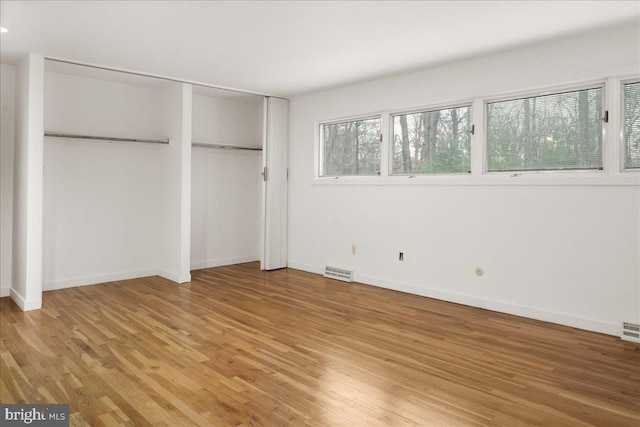 unfurnished bedroom featuring hardwood / wood-style flooring