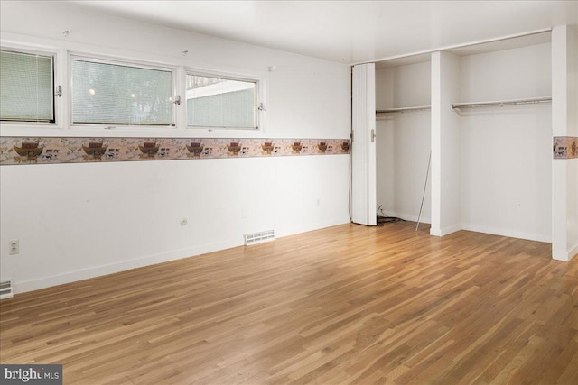 unfurnished bedroom featuring hardwood / wood-style flooring