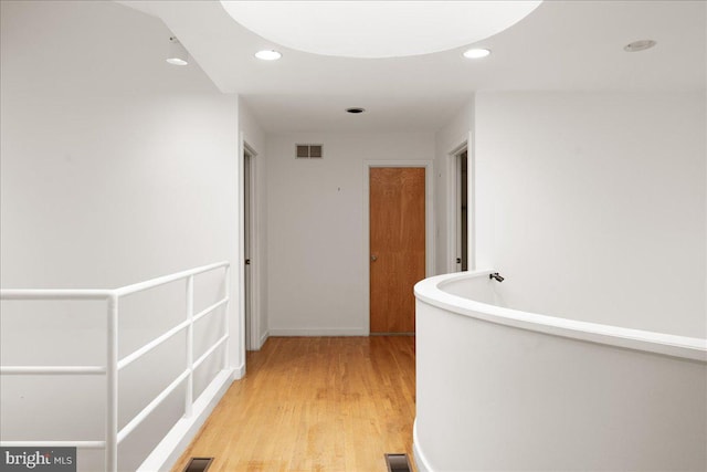 hall with light hardwood / wood-style flooring