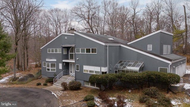 view of front of house with a sunroom