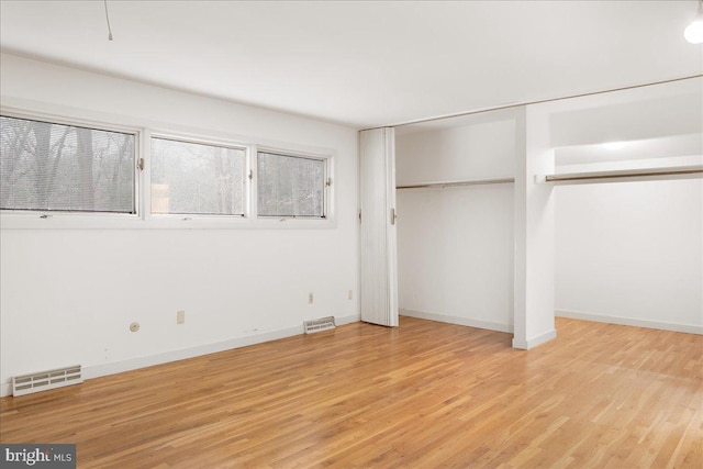 unfurnished bedroom with light wood-type flooring