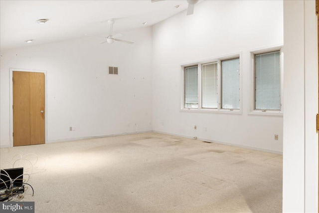 unfurnished room with high vaulted ceiling, ceiling fan, and light colored carpet