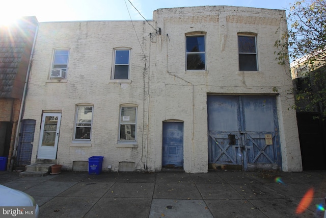 view of front of home featuring cooling unit and a patio area