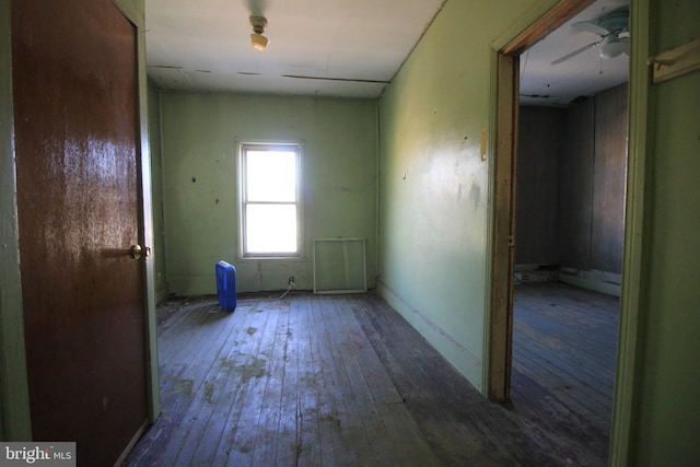 spare room with ceiling fan and wood-type flooring