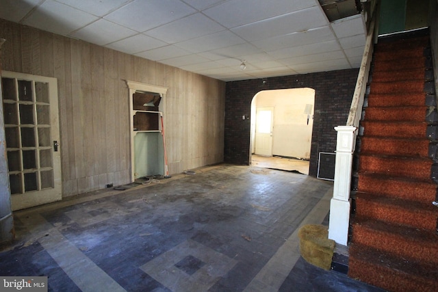 empty room featuring wood walls