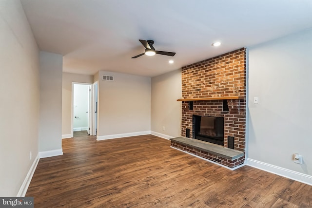 unfurnished living room with ceiling fan, wood-type flooring, and a fireplace