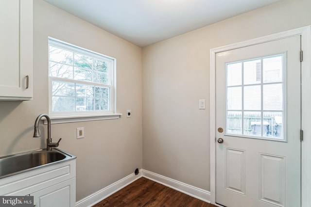 laundry area with cabinets, electric dryer hookup, a wealth of natural light, and sink