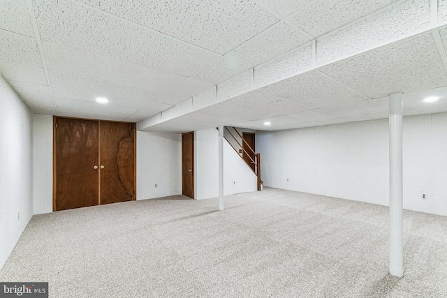 basement with carpet and a drop ceiling