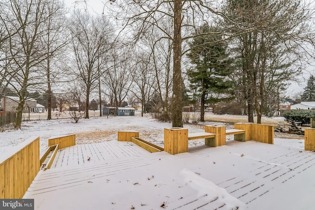 yard covered in snow featuring a deck