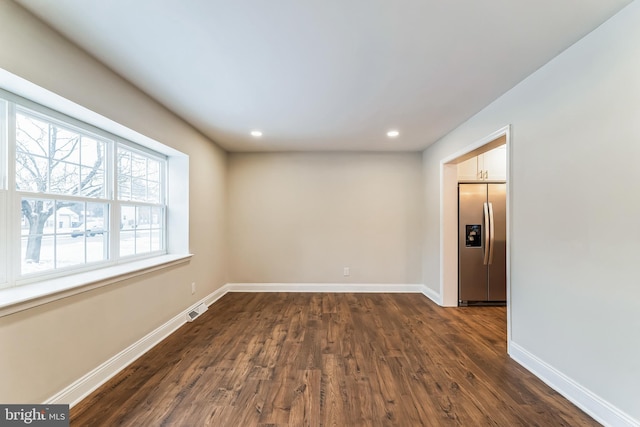 empty room featuring dark wood-type flooring