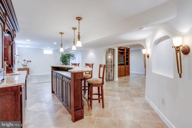 dining space with recessed lighting, baseboards, and arched walkways