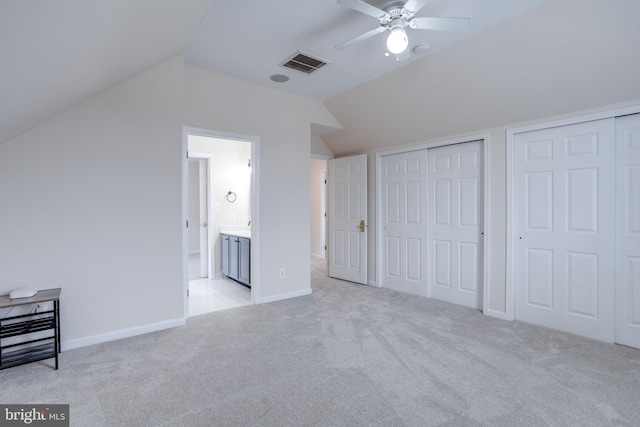 additional living space with visible vents, baseboards, light colored carpet, vaulted ceiling, and a ceiling fan