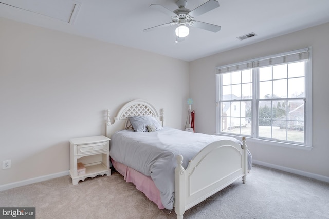 carpeted bedroom with visible vents, multiple windows, and baseboards