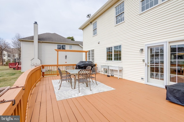 wooden deck with a grill and outdoor dining area