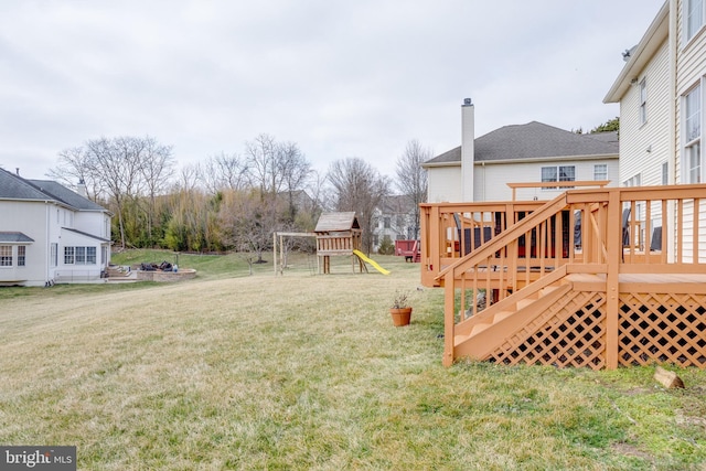 view of yard with a wooden deck and a playground