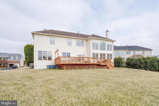 back of property featuring a yard, central AC unit, a deck, and a chimney