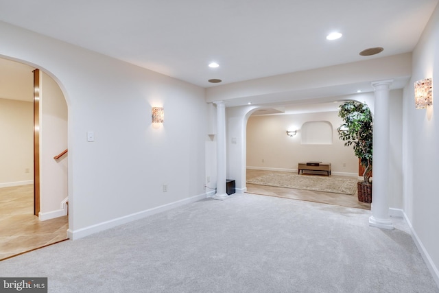 empty room with baseboards, stairway, light carpet, recessed lighting, and arched walkways