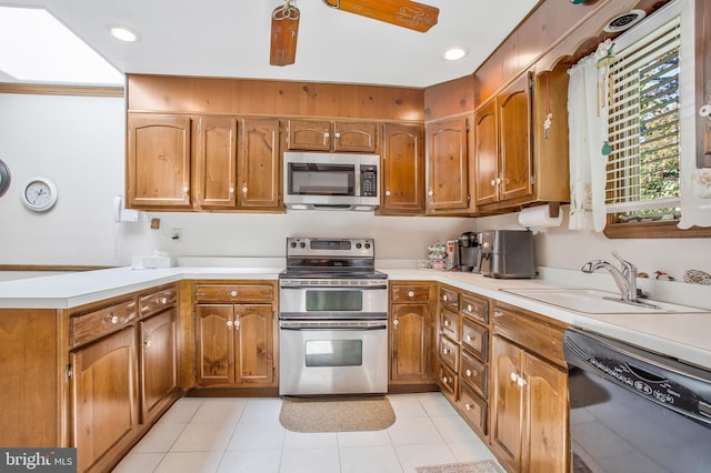 kitchen featuring appliances with stainless steel finishes, light tile patterned floors, ceiling fan, and sink