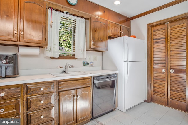 kitchen featuring ornamental molding, sink, dishwasher, white fridge, and light tile patterned flooring