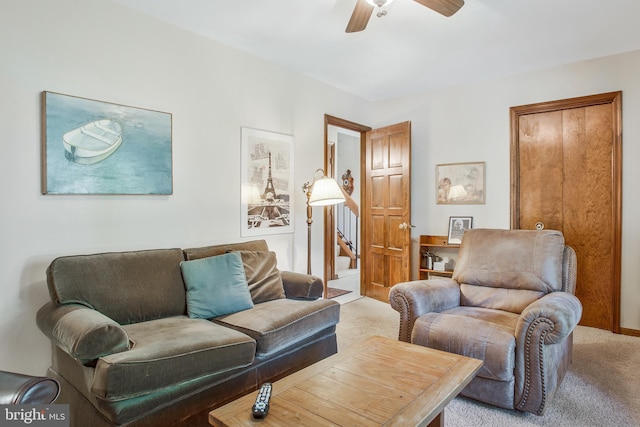 living room featuring ceiling fan and light colored carpet