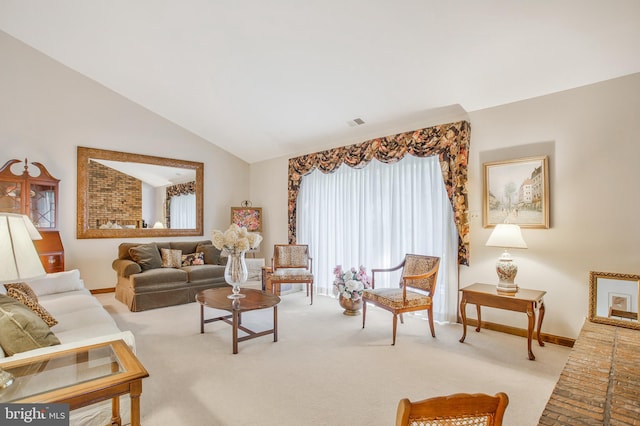 carpeted living room featuring vaulted ceiling