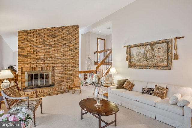 carpeted living room with lofted ceiling and a brick fireplace