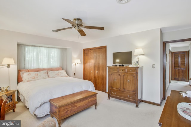 bedroom featuring ceiling fan, a closet, and light carpet