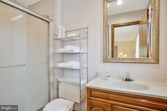 bathroom featuring vanity, toilet, and walk in shower