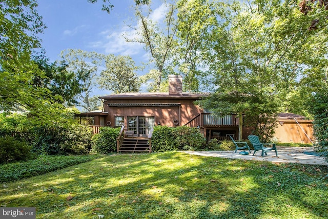 back of house with a patio area, a yard, and a wooden deck