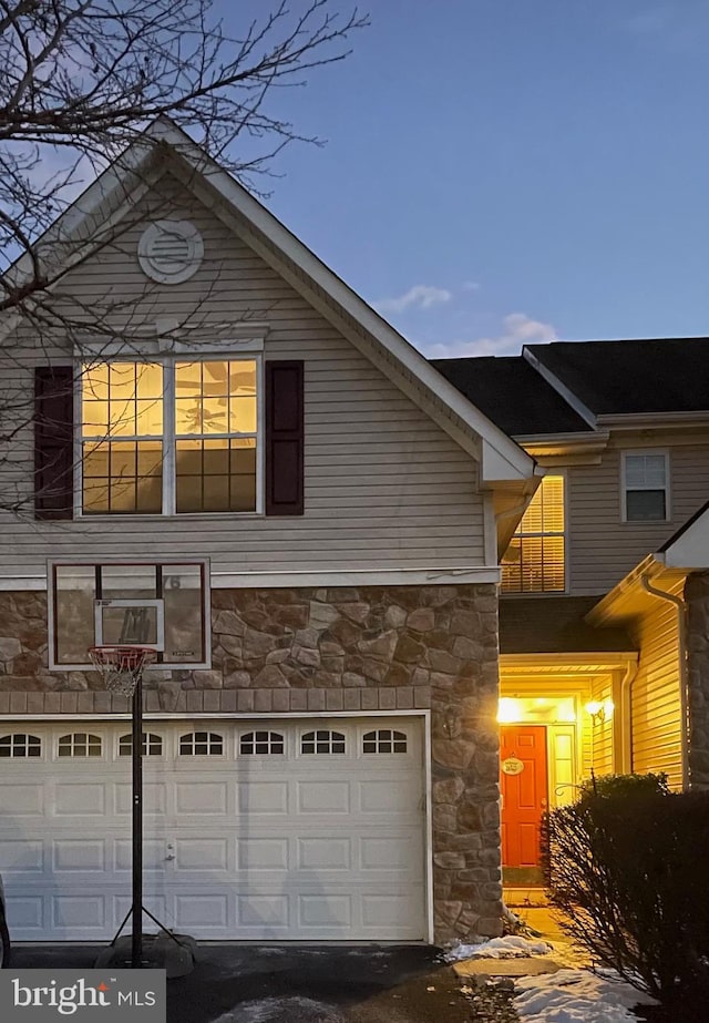 view of home's exterior featuring a garage and cooling unit