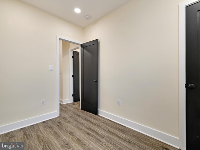 unfurnished room with hardwood / wood-style flooring