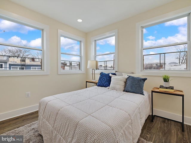 bedroom with dark wood-type flooring