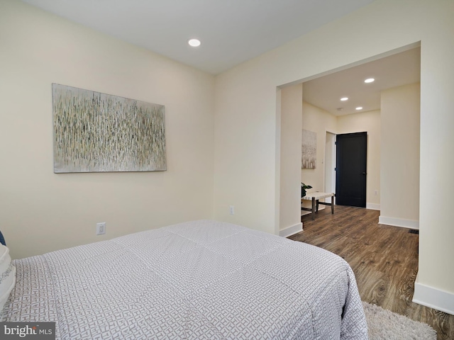 bedroom with dark wood-type flooring