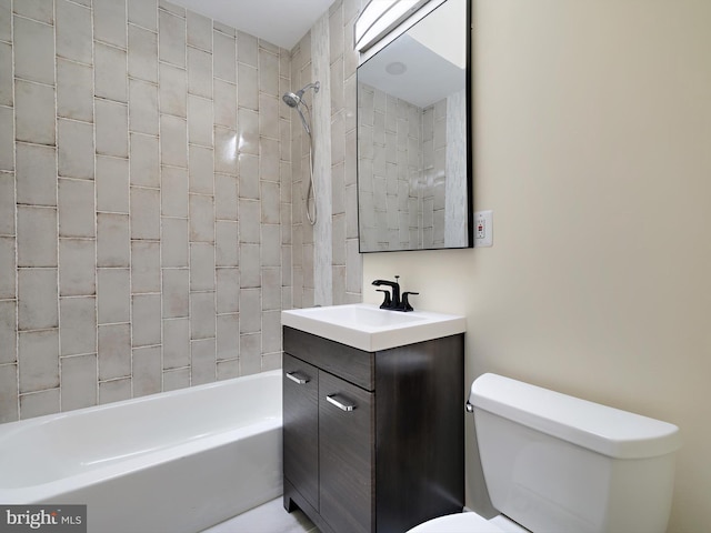 full bathroom with toilet, tiled shower / bath, and vanity