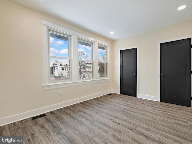 unfurnished bedroom with hardwood / wood-style floors