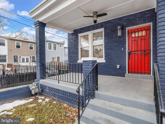 entrance to property with covered porch and ceiling fan