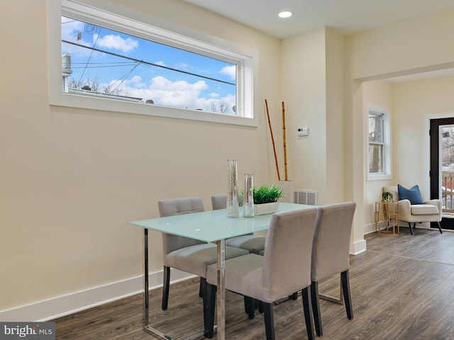 dining space featuring dark wood-type flooring