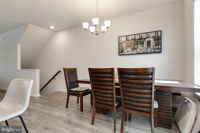 dining space featuring a chandelier and light hardwood / wood-style flooring