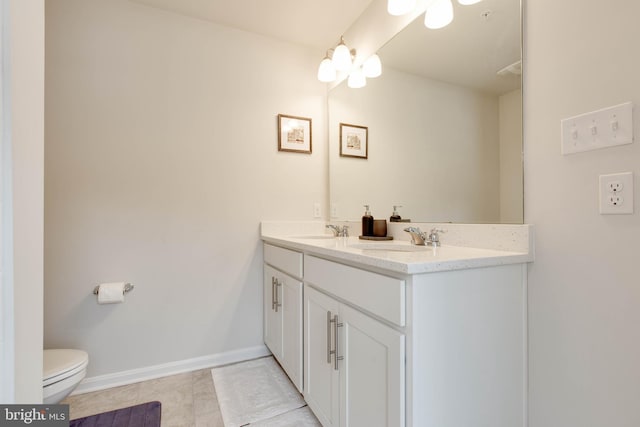 bathroom featuring tile patterned floors, toilet, and vanity