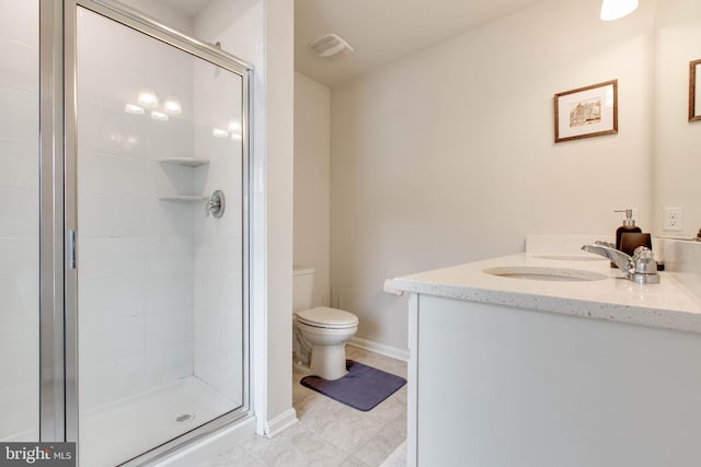 bathroom with tile patterned flooring, toilet, vanity, and walk in shower