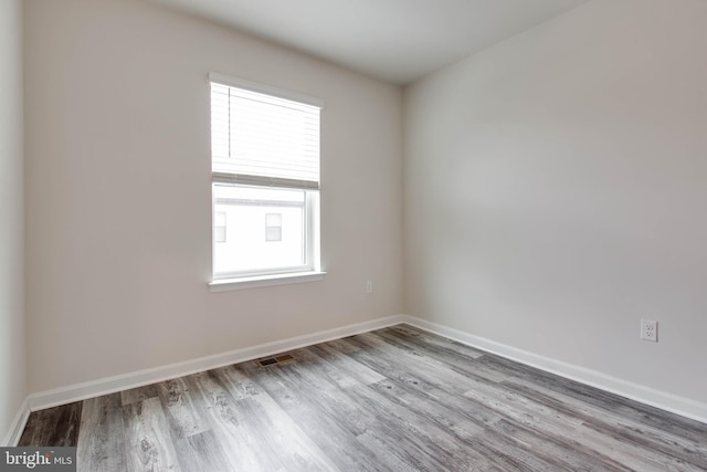 spare room featuring hardwood / wood-style flooring