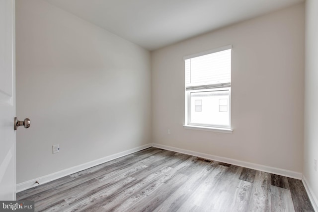 unfurnished room with light hardwood / wood-style floors