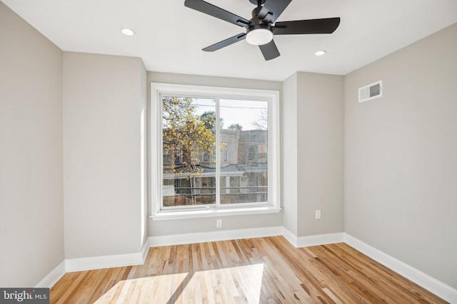 empty room featuring ceiling fan and light hardwood / wood-style floors