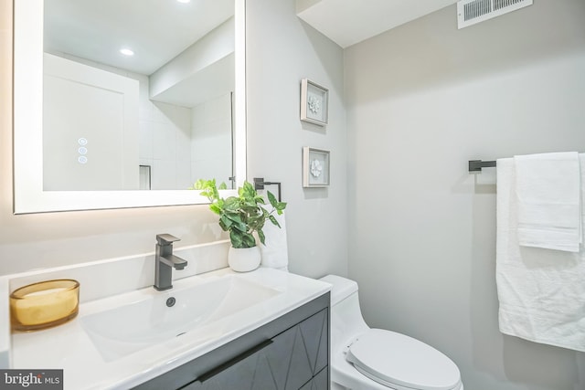 bathroom featuring vanity and toilet