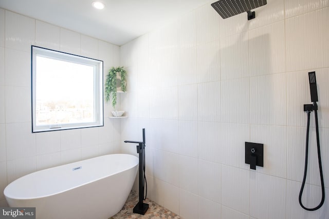 bathroom with plus walk in shower and tile walls