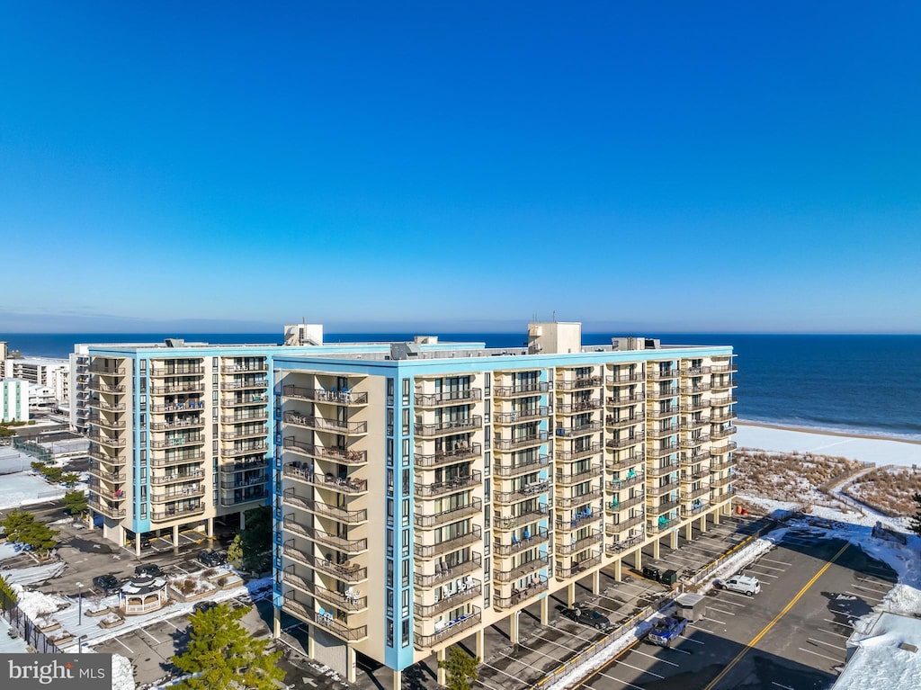 view of property featuring a view of the beach and a water view