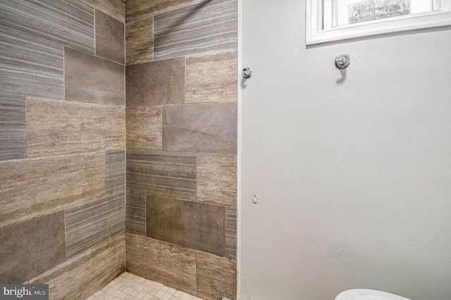 bathroom with tiled shower