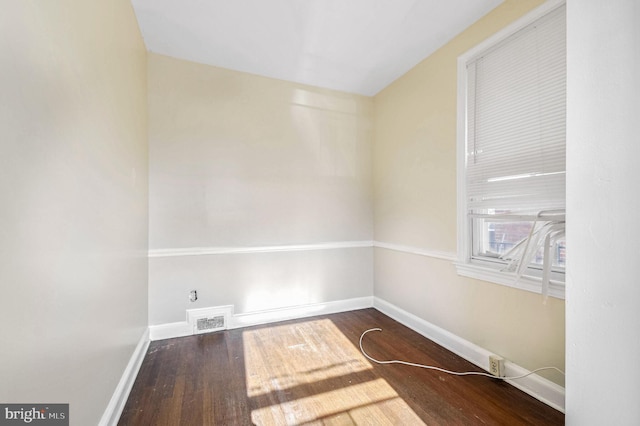 unfurnished room featuring dark hardwood / wood-style floors