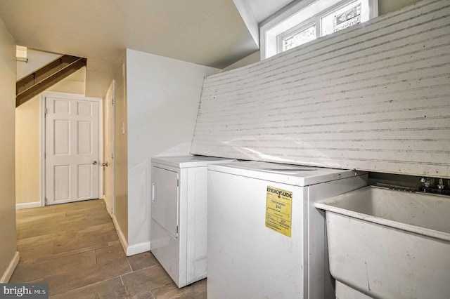 clothes washing area with sink and washing machine and dryer