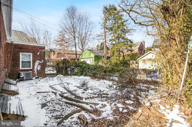 yard layered in snow with central AC unit